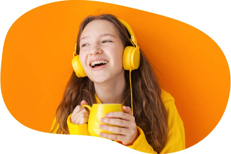 Girl wearing headphones with a drink