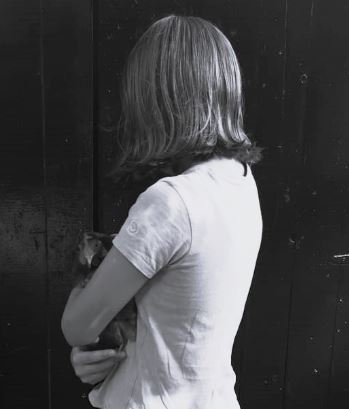 A young girl holding her favourite chicken Stella.
