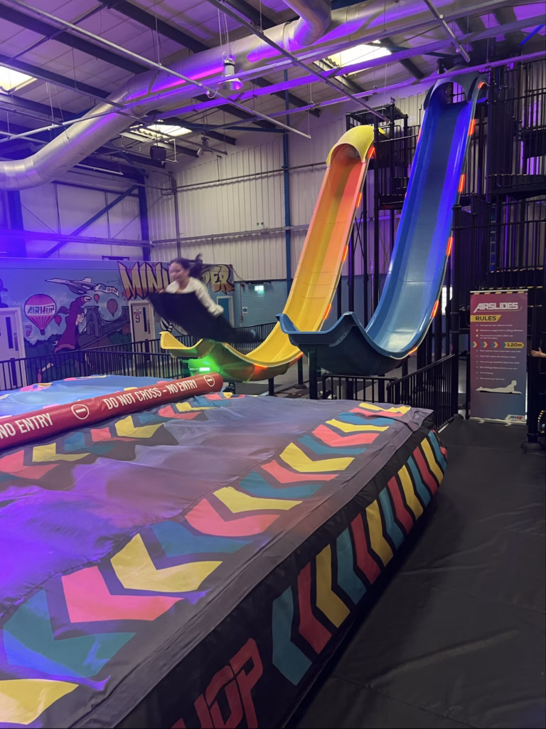 Young person sliding down the slide. 