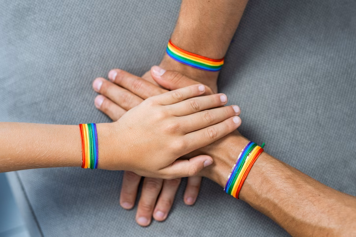Hands with rainbow bands